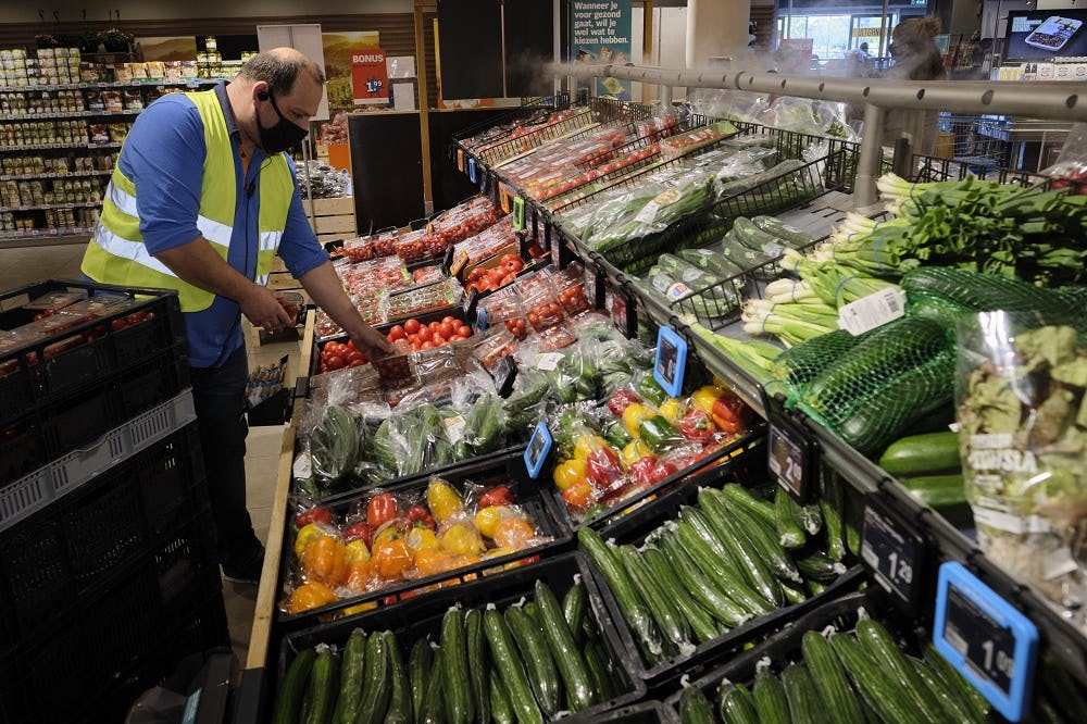 Medewerker van Albert Heijn Hendrik-Ido-Ambacht vult het AGF-schap.