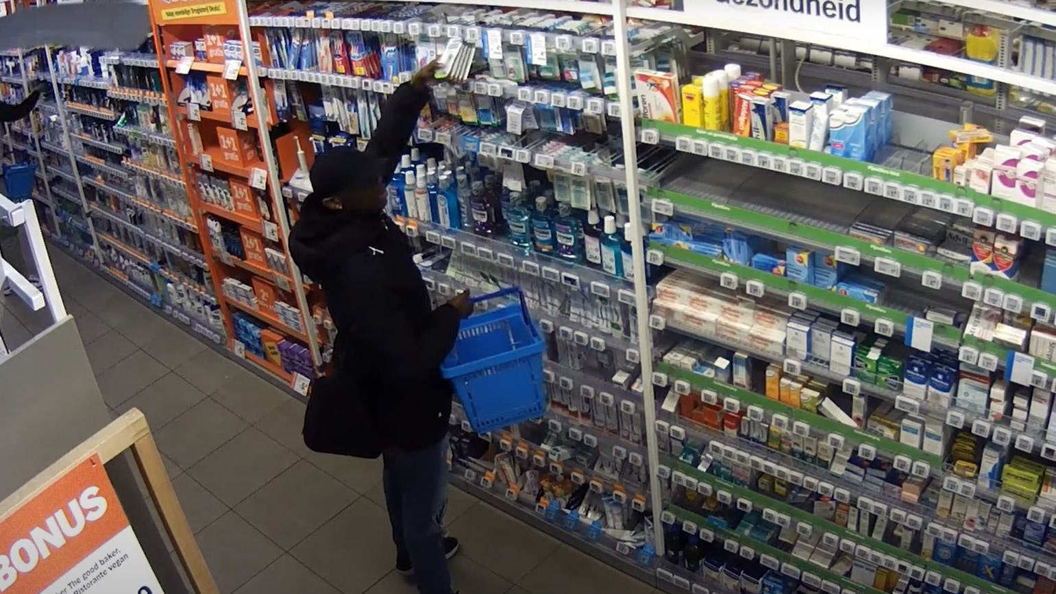 Een dief aan het werk in AH Hoevelaken. Foto: Still uit video Politie.nl