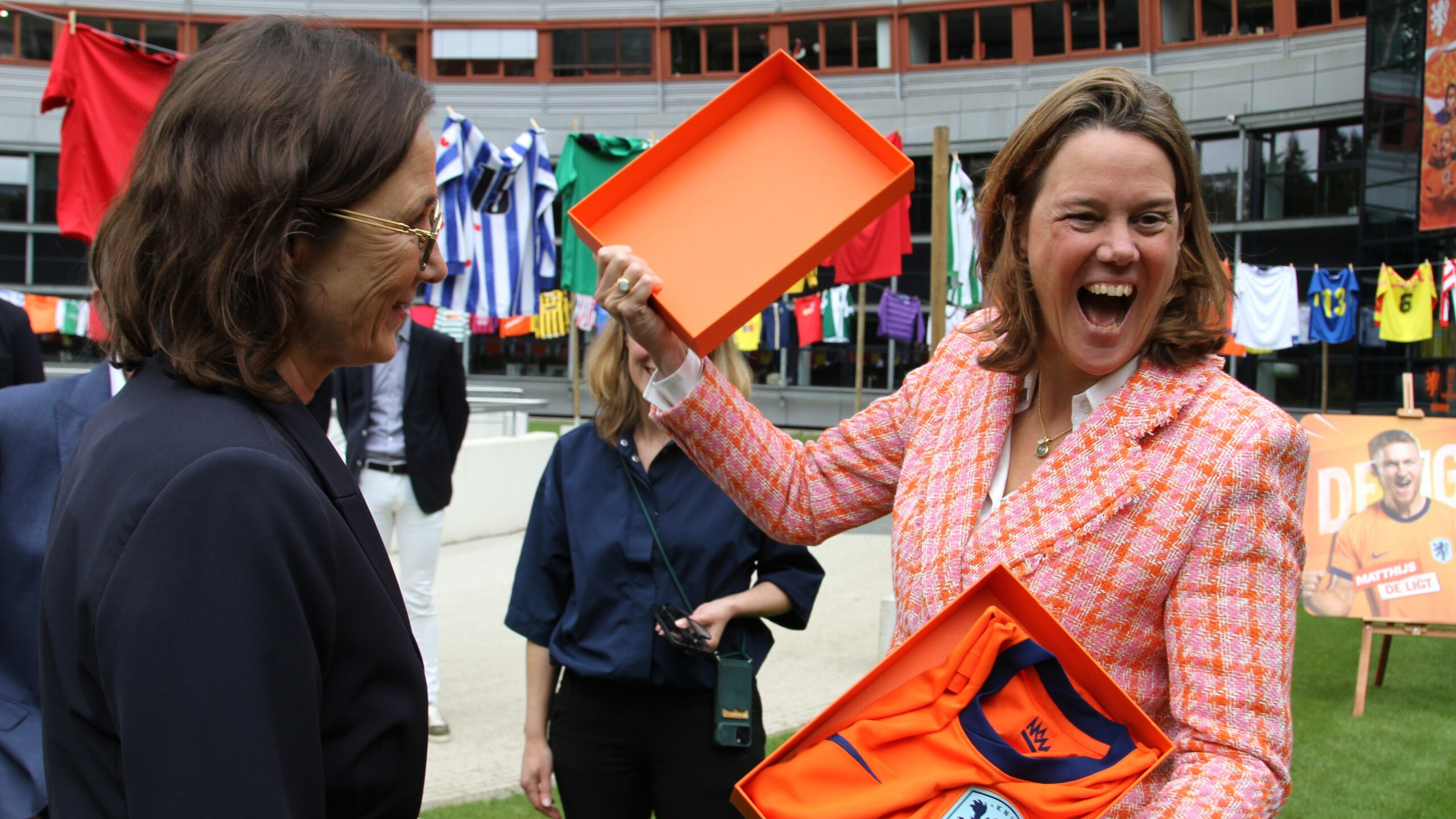 Marianne van Leeuwen (KNVB) overhandigt een Oranje-shirt aan Marit van Egmond (AH), die daar erg blij mee is. Foto: Distrifood